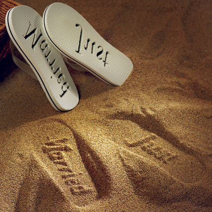The sand imprint from the bride’s Just Married Flip Flop.