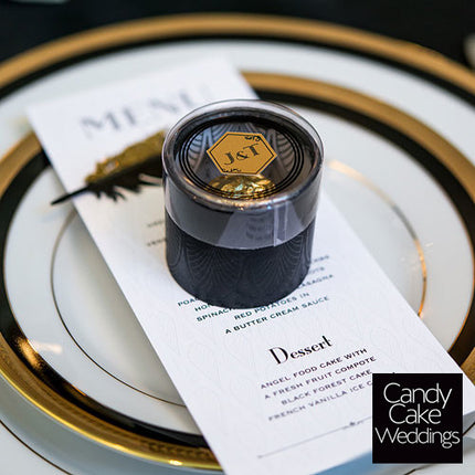 Art Deco Cylinder Boxes With Clear Lid on top of a wedding menu.
