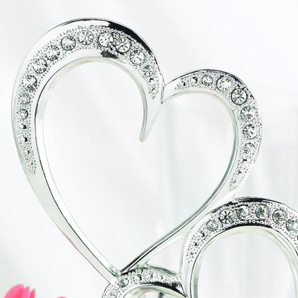 A close up of the Sparkling Rhinestone Heart Wedding Cake Topper.
