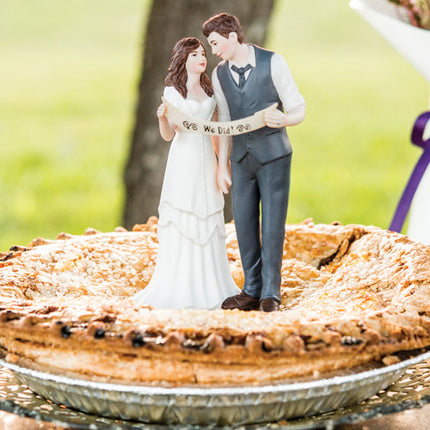 A cute Indie Wedding Couple Porcelain Cake Top on top of a blueberry pie.