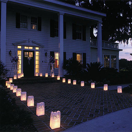 Paper lanterns lining a wedding walkway at night.