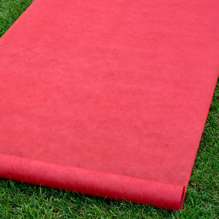 Red Wedding Aisle Runner on top of grass.