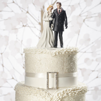 Winter wonderland wedding couple figurine on top of a white cake.